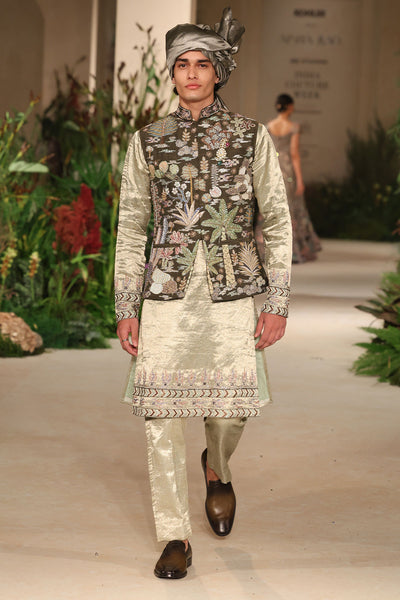 Motion shot showing the natural movement of the brocade kurta pants styled with the bundi.
