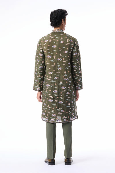 Back profile of the lush green applique embellished organza kurta paired with cotton lycra pants.