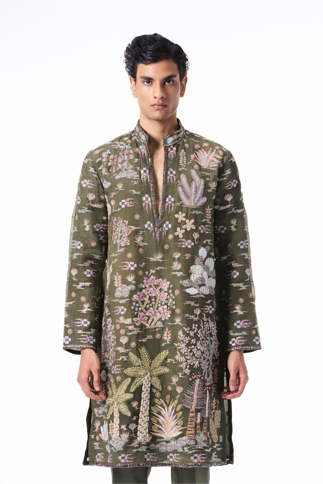 Closeup showing the applique embellishment on the lush green organza kurta.