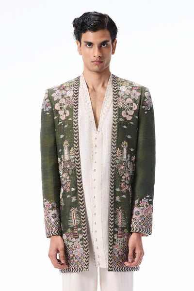 Closeup showing the applique embellishment on the lush green raw silk open jacket.
