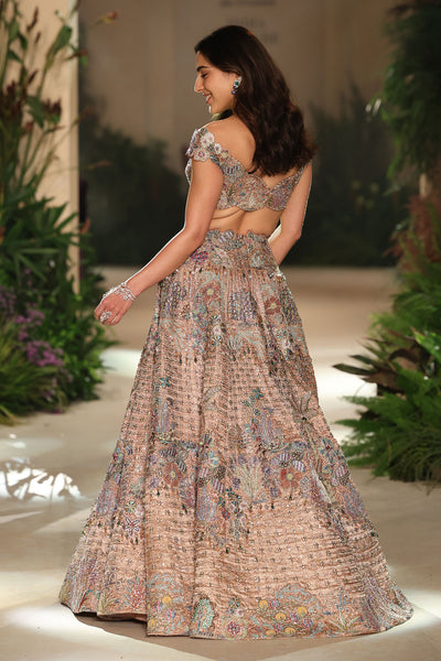 Back profile of the rose gold applique embellished brocade lehenga with halter-strap tassel blouse.
