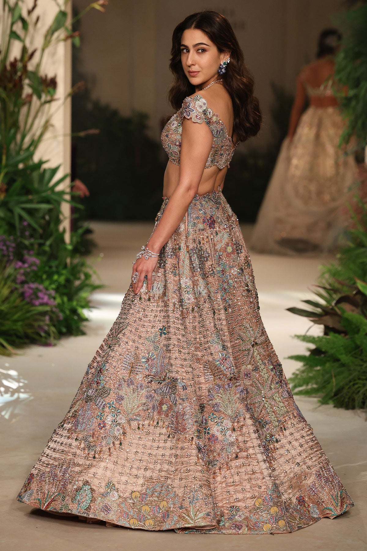 Motion shot capturing the movement and flare of the brocade lehenga.