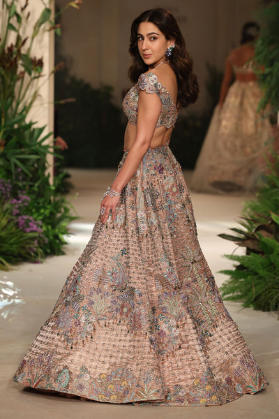 Motion shot capturing the movement and flare of the brocade lehenga.