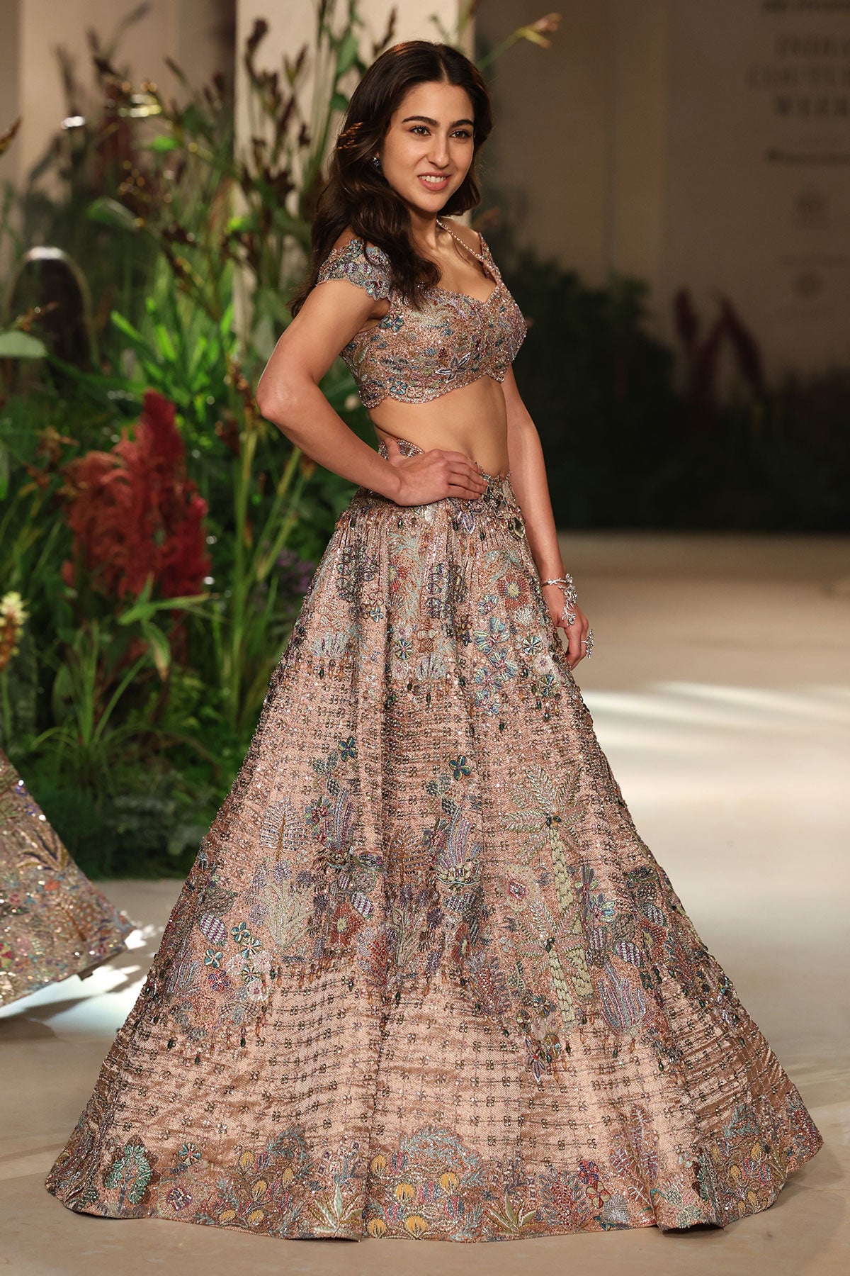 Side angle view of the rose gold Banarasi brocade lehenga featuring geometric check and floral motifs.