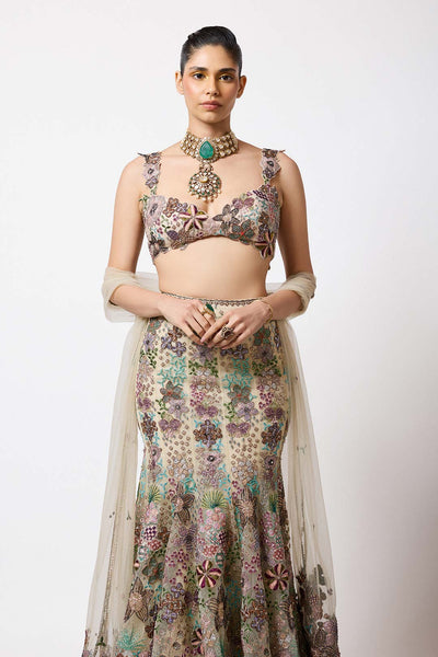 Woman in beige net bustier side profile with embroidery