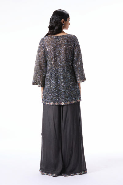 “Gunmetal tulle sequin embellished kurta styled with flowy chiffon sharara pants.”