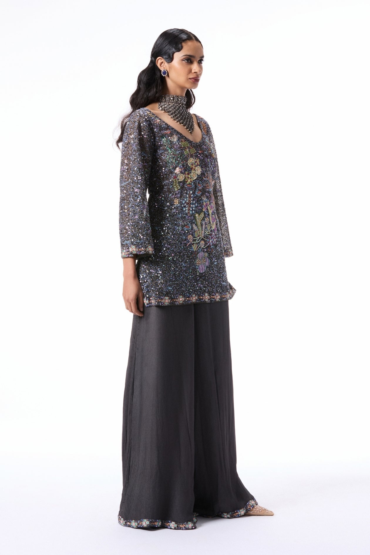 “Applique embellished gunmetal tulle kurta paired with chiffon sharara and sheer tulle dupatta.”