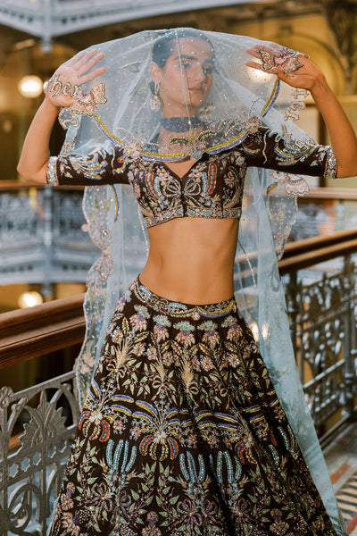 Close-up of Aisha Rao lehenga with sheer tulle dupatta over face