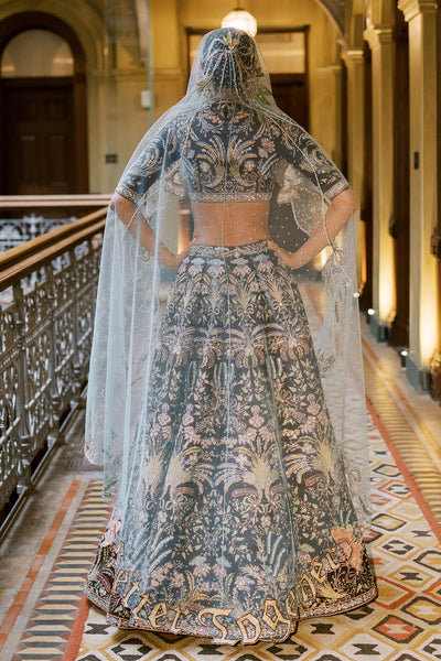Rear view of Aisha Rao brown raw silk lehenga and sheer tulle dupatta
