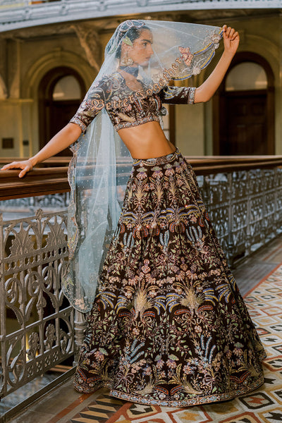 Woman wearing Aisha Rao lehenga with tulle net embellished dupatta