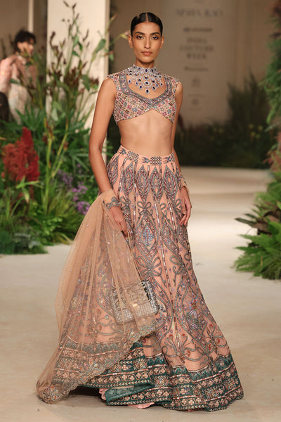 Styled look of the Wild At Heart cantaloupe-teal tulle lehenga with coordinated blouse and dupatta.