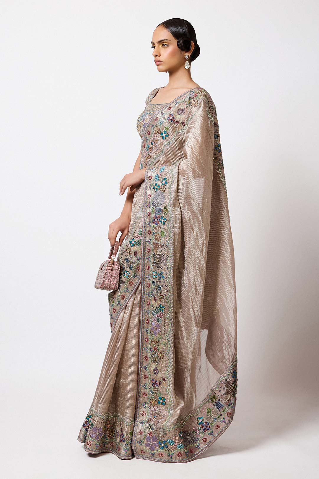 Woman in champagne Banarasi applique attire right profile
