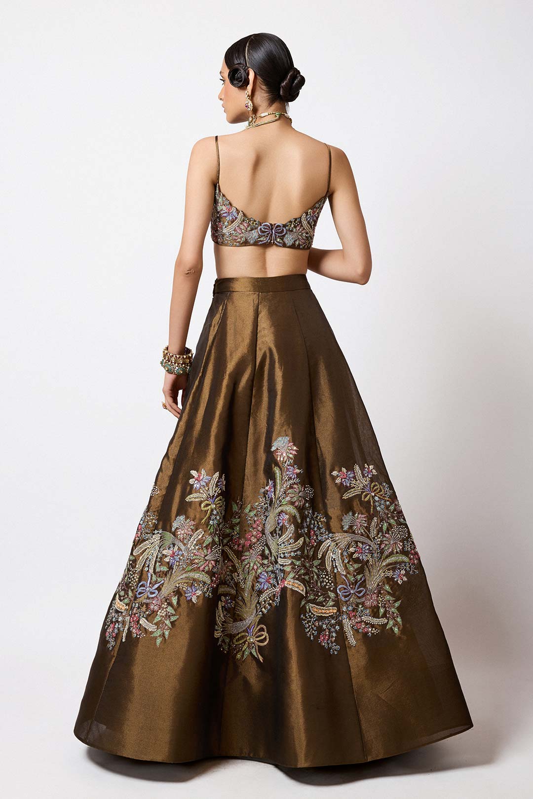 Back profile of embellished copper tissue lehenga
