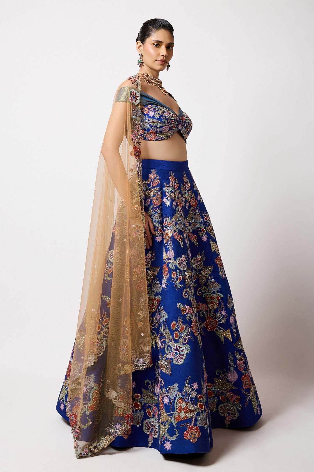 Woman in electric blue applique lehenga right profile