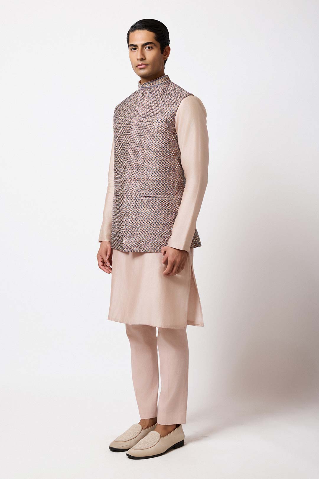 Side view of the gold raw silk bundi showing its sharp silhouette.