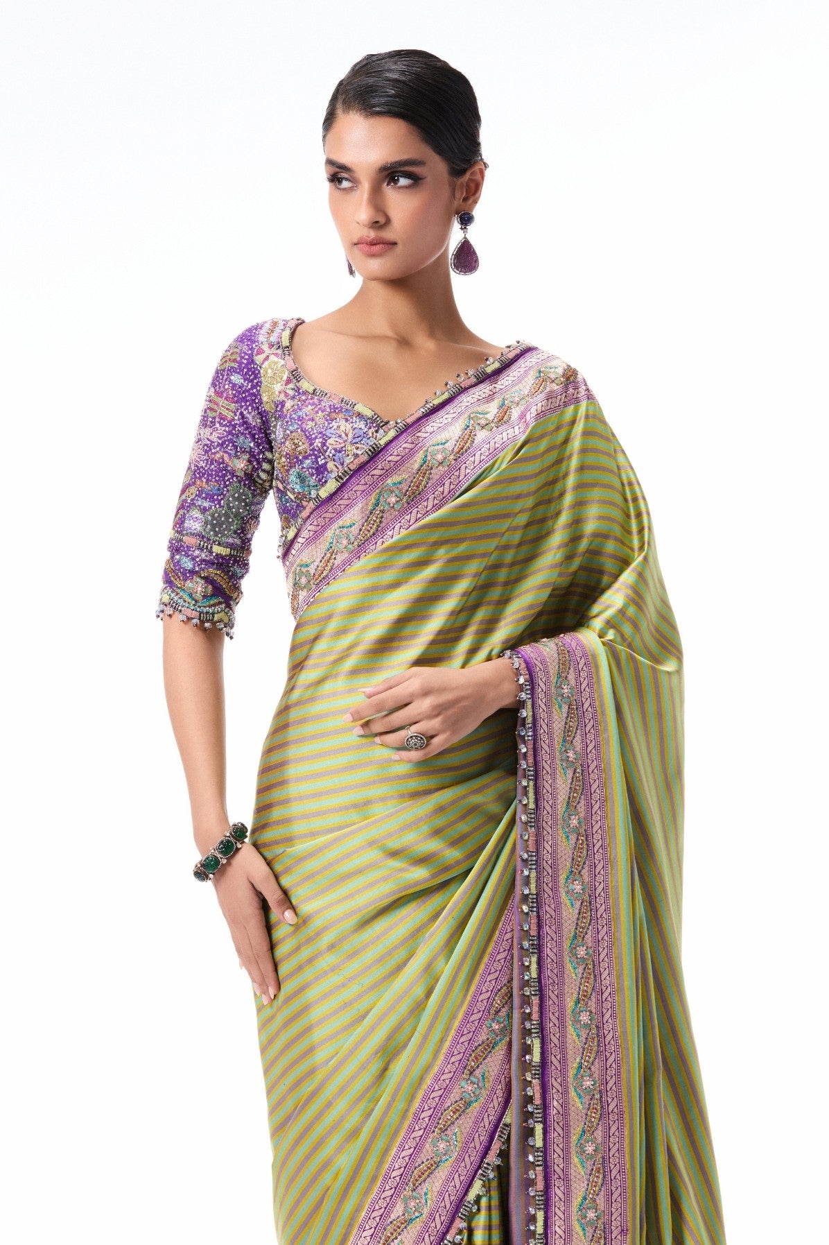 Pallu drape shot of the green-purple Banarasi silk saree showcasing applique accents.