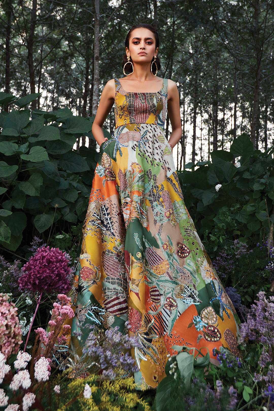 Woman wearing Aisha Rao green satin organza embellished gown