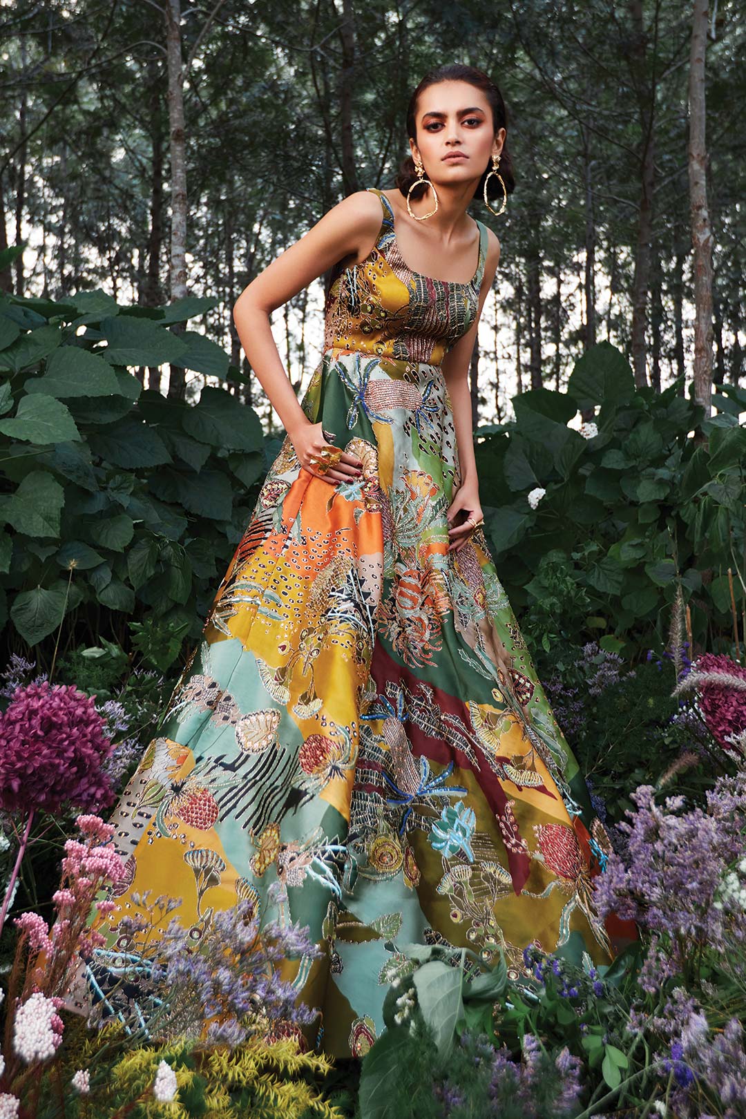 Woman wearing green Aisha Rao gown side view right angle