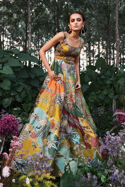 Woman wearing green Aisha Rao gown side view right angle