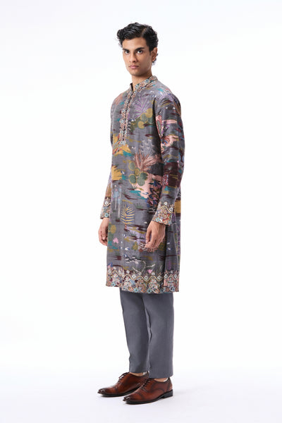 Closeup showing pockets or functional detailing on the gunmetal printed raw silk kurta.