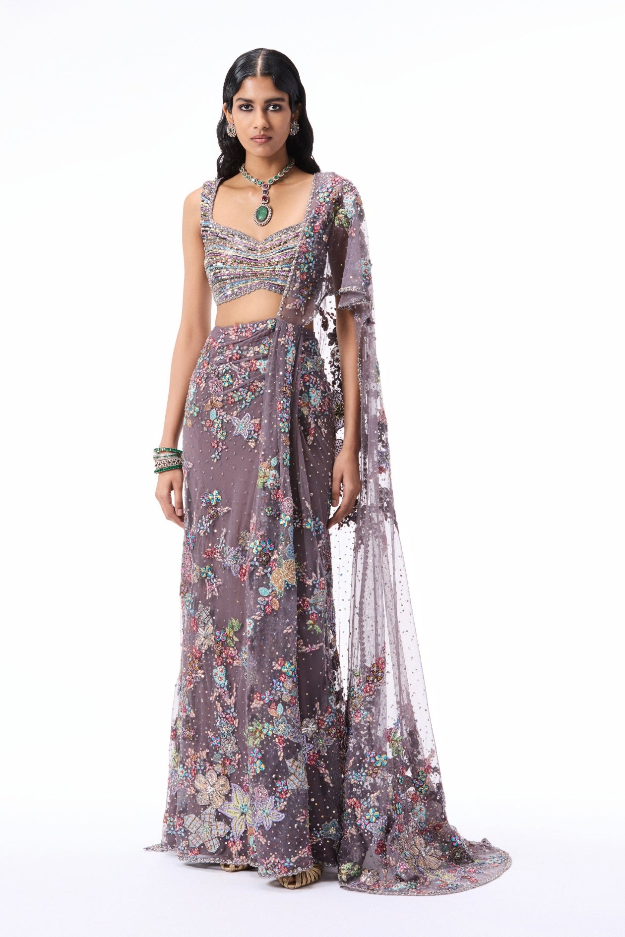 “Gunmetal heavy tulle draped saree featuring applique work paired with a tulle blouse from the Wild At Heart collection.”