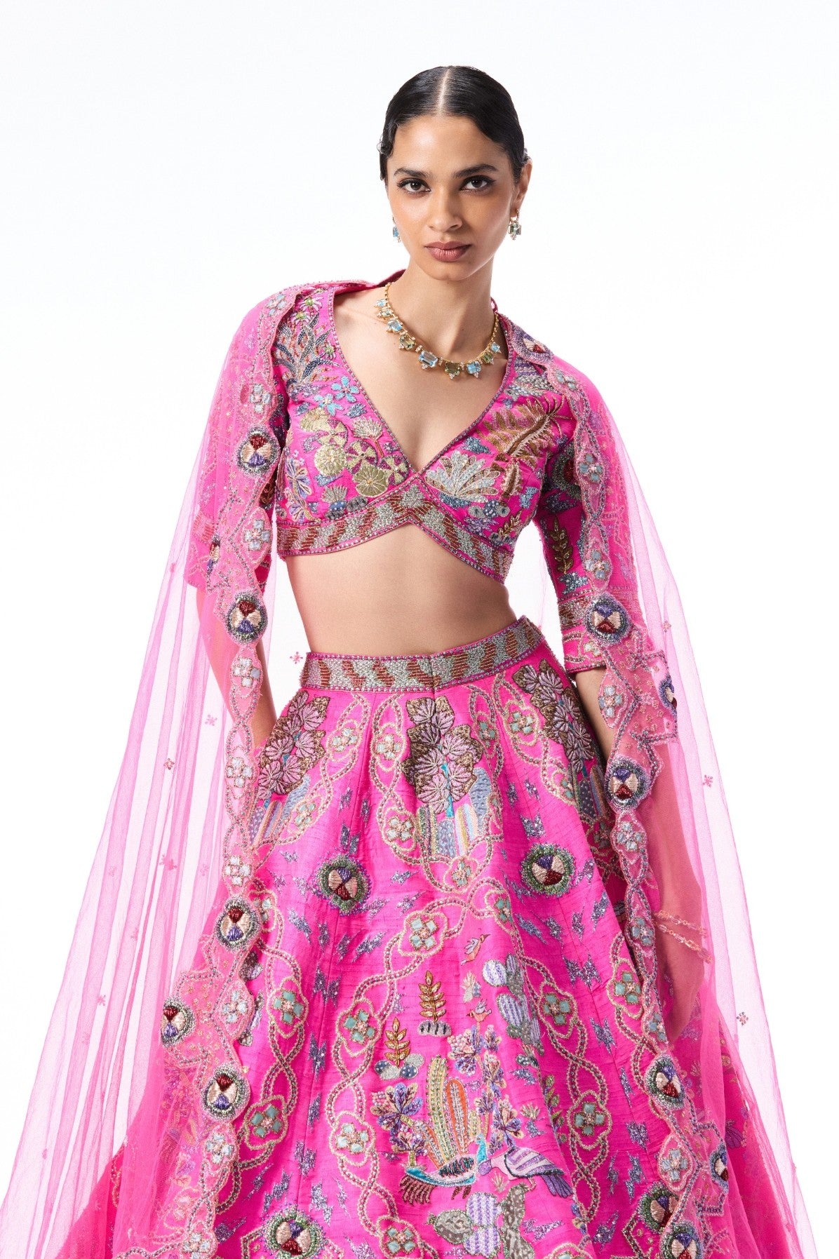 Woman wearing a pink embroidered traditional outfit 