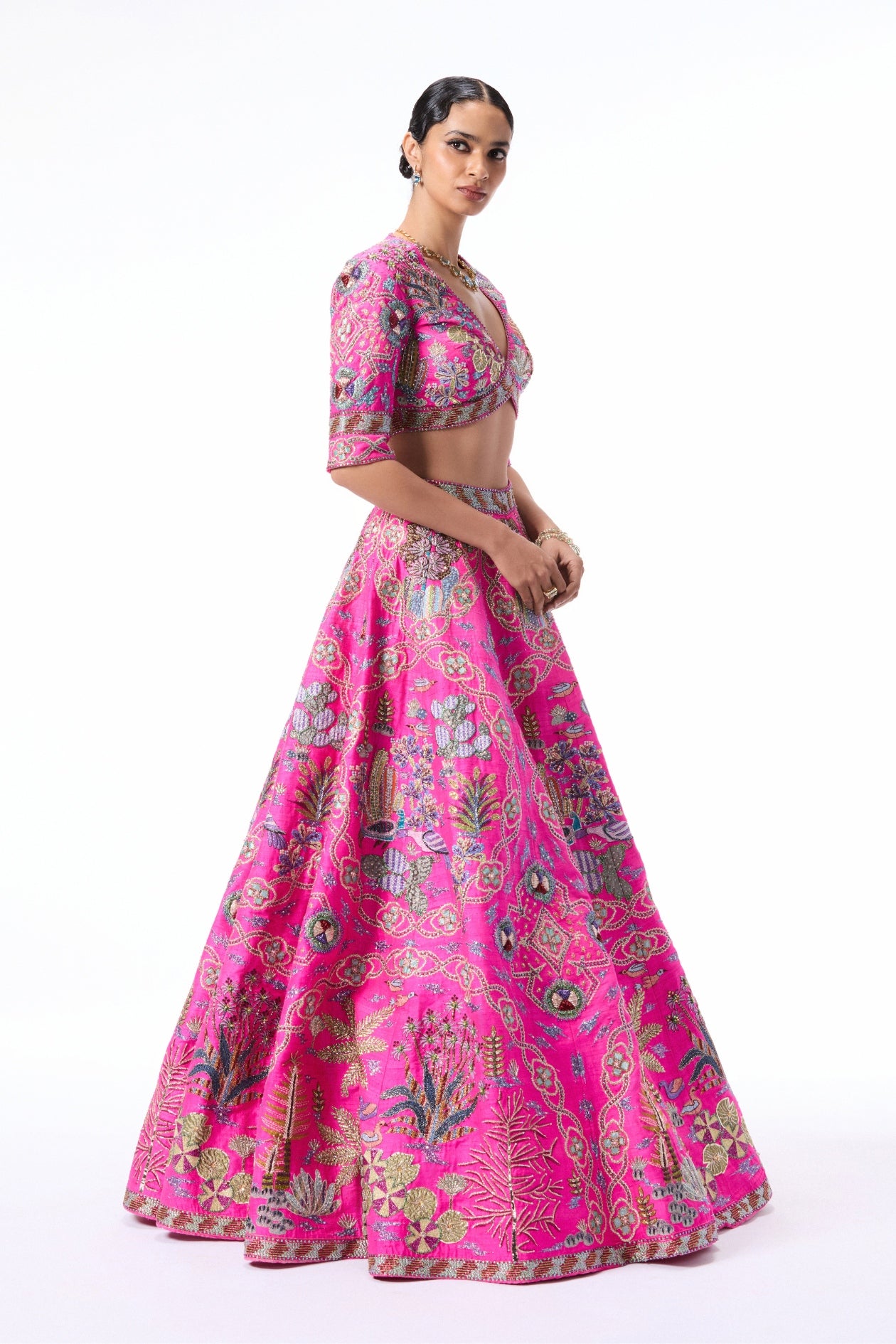 Side angle view of the hot pink raw silk lehenga highlighting its graceful flare.
