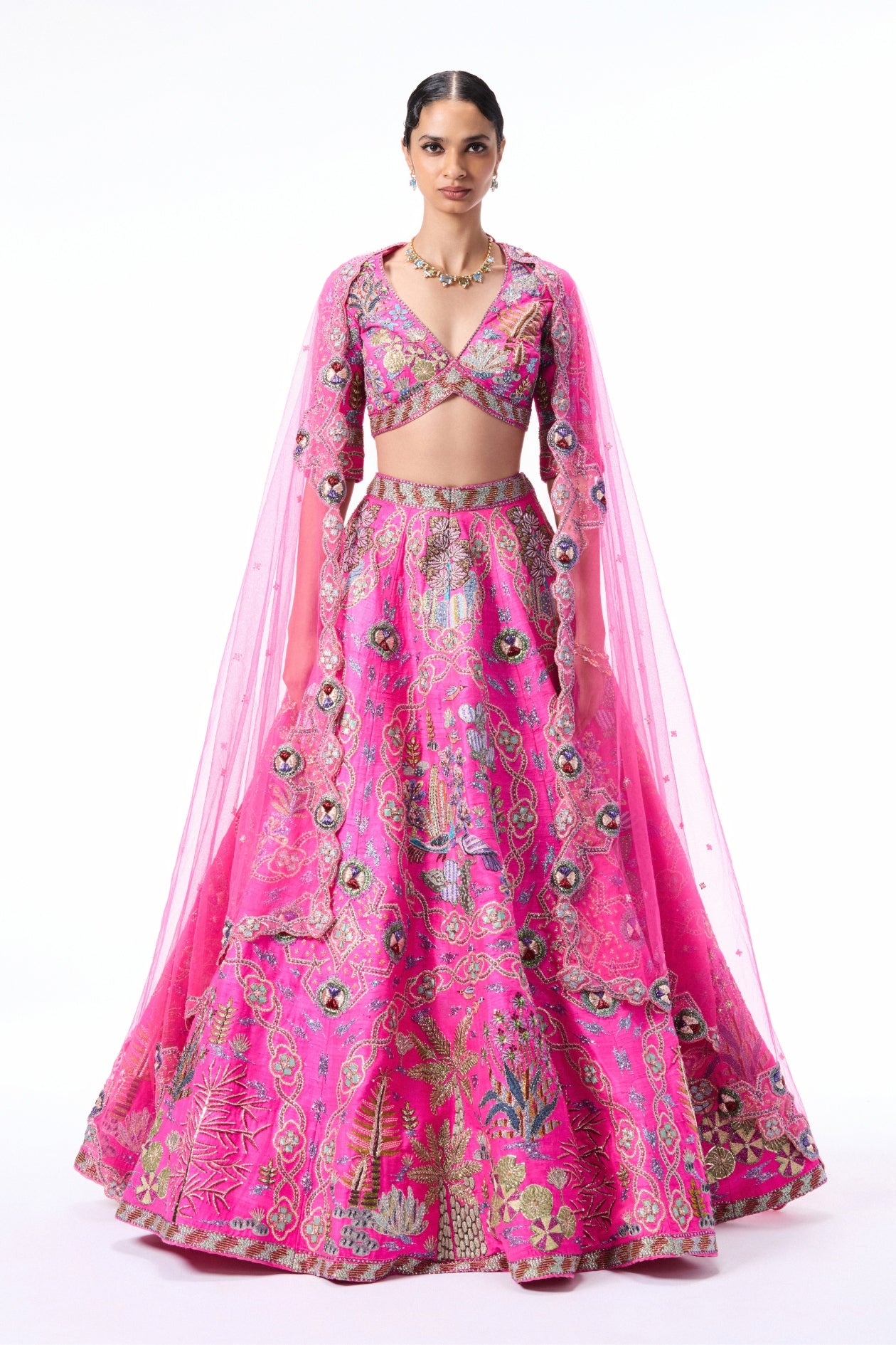 Woman wearing a pink embroidered traditional outfit 