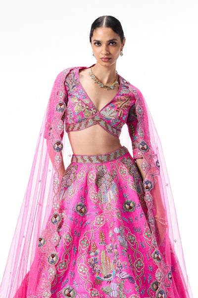 Woman wearing a pink embroidered traditional outfit 