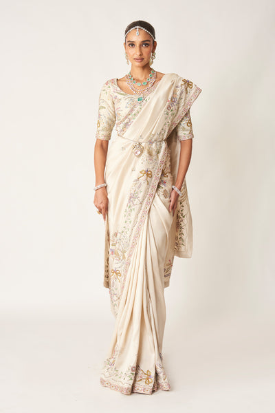 Woman wearing ivory embellished dupion silk saree