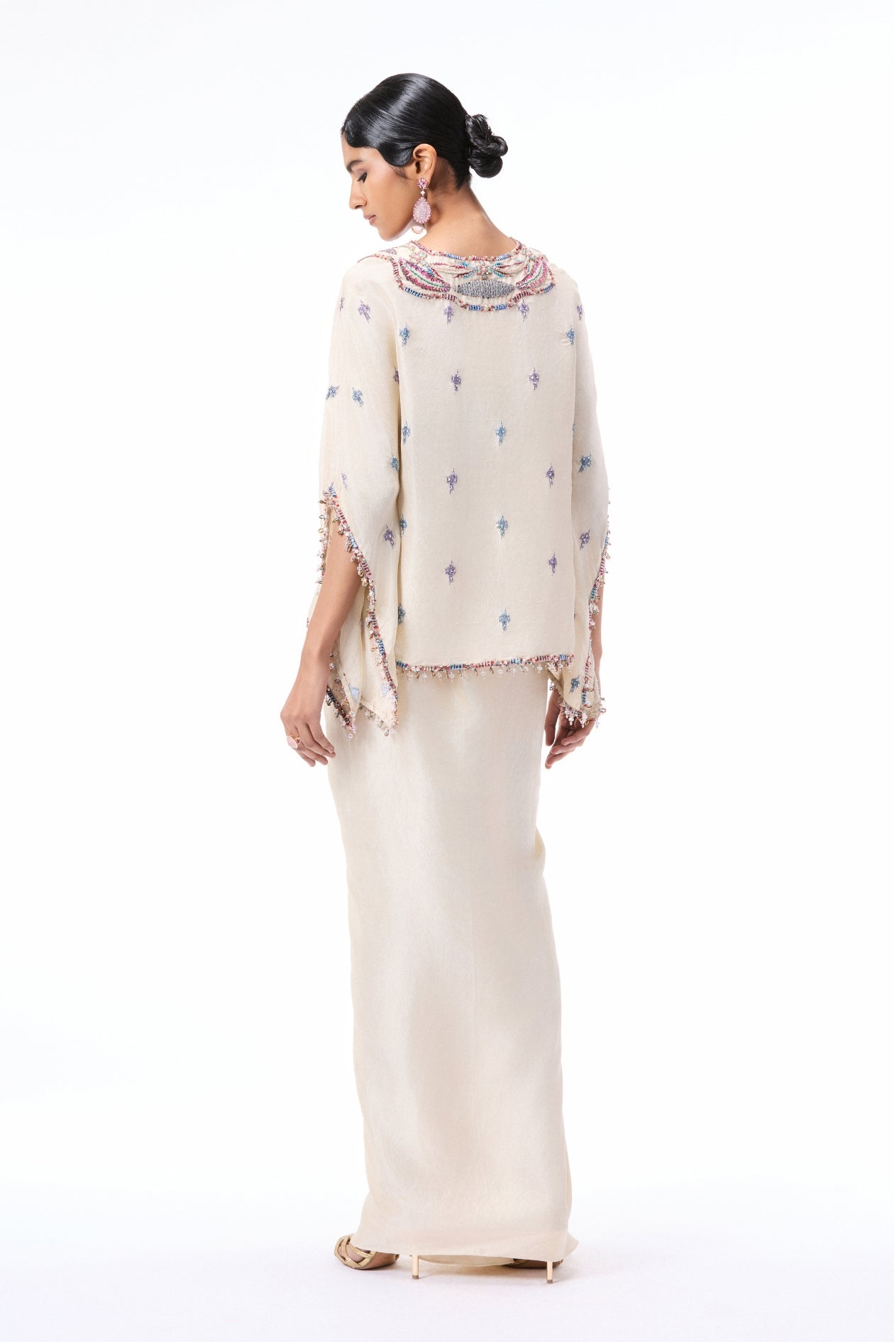 Back profile of the ivory appliqué embellished dupion silk kurta paired with the pleated draped skirt.