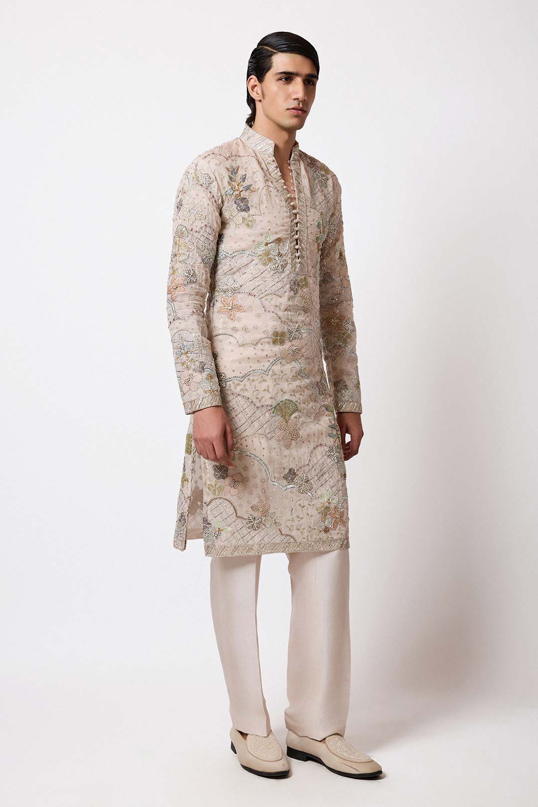 Close-up of left sleeve scallop hem and embroidery work