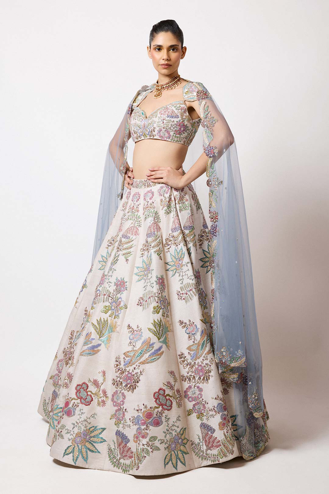 Woman wearing Aisha Rao ivory raw silk lehenga front view