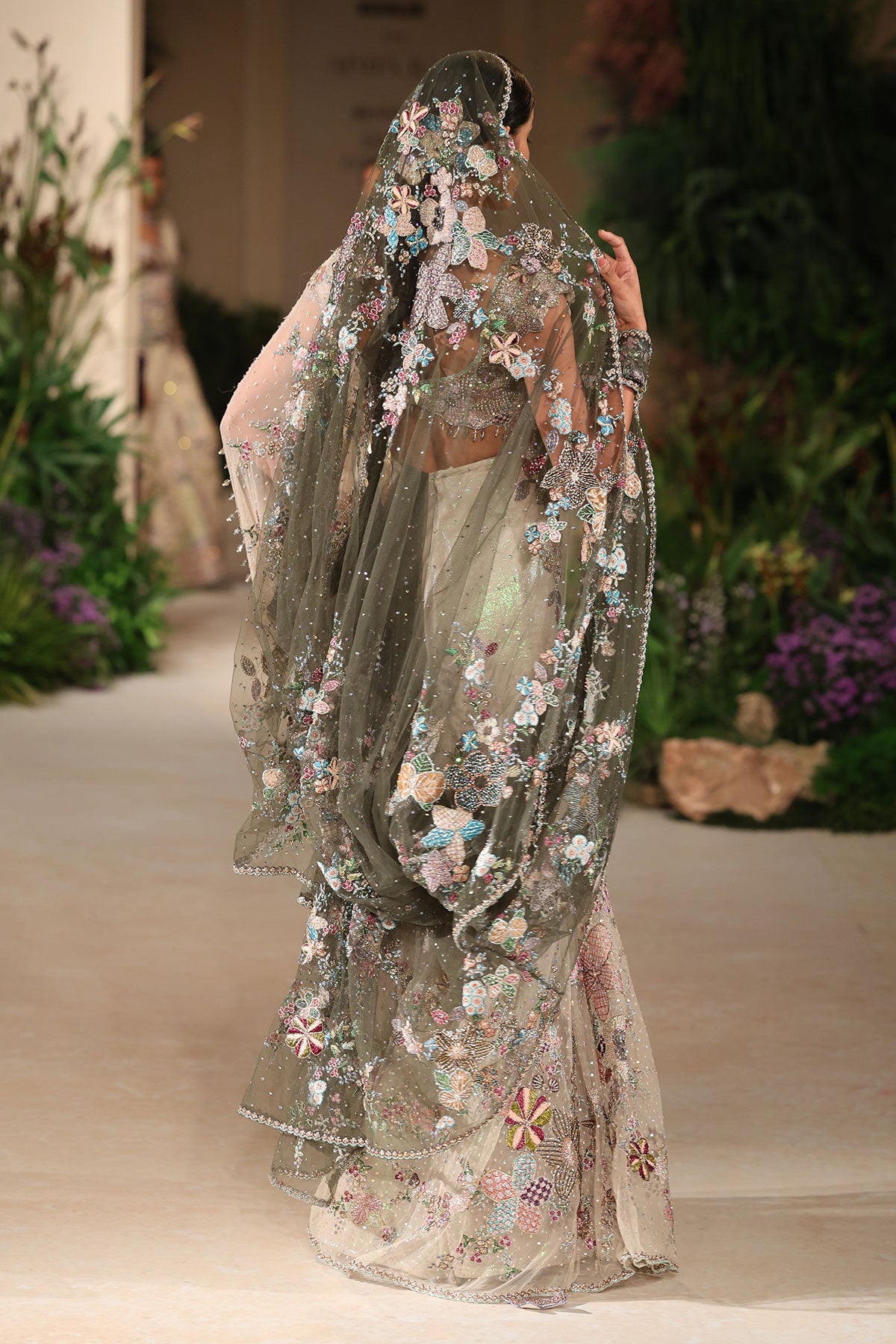 “Ivory tulle saree with gentle cascading drape and a clean couture aesthetic.”