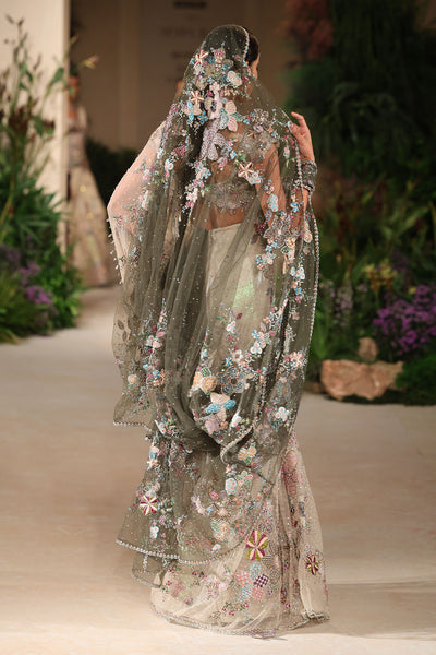 “Ivory tulle saree with gentle cascading drape and a clean couture aesthetic.”