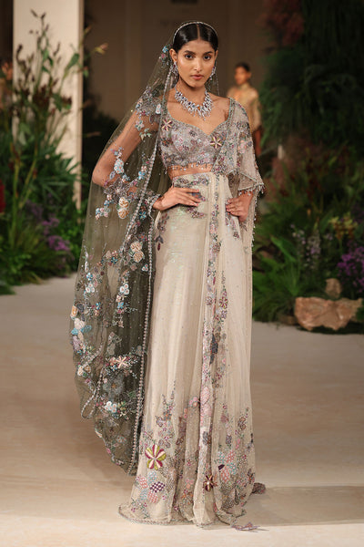 “Ivory tulle saree designed with layered tulle draping and a modern sculpted fall.”