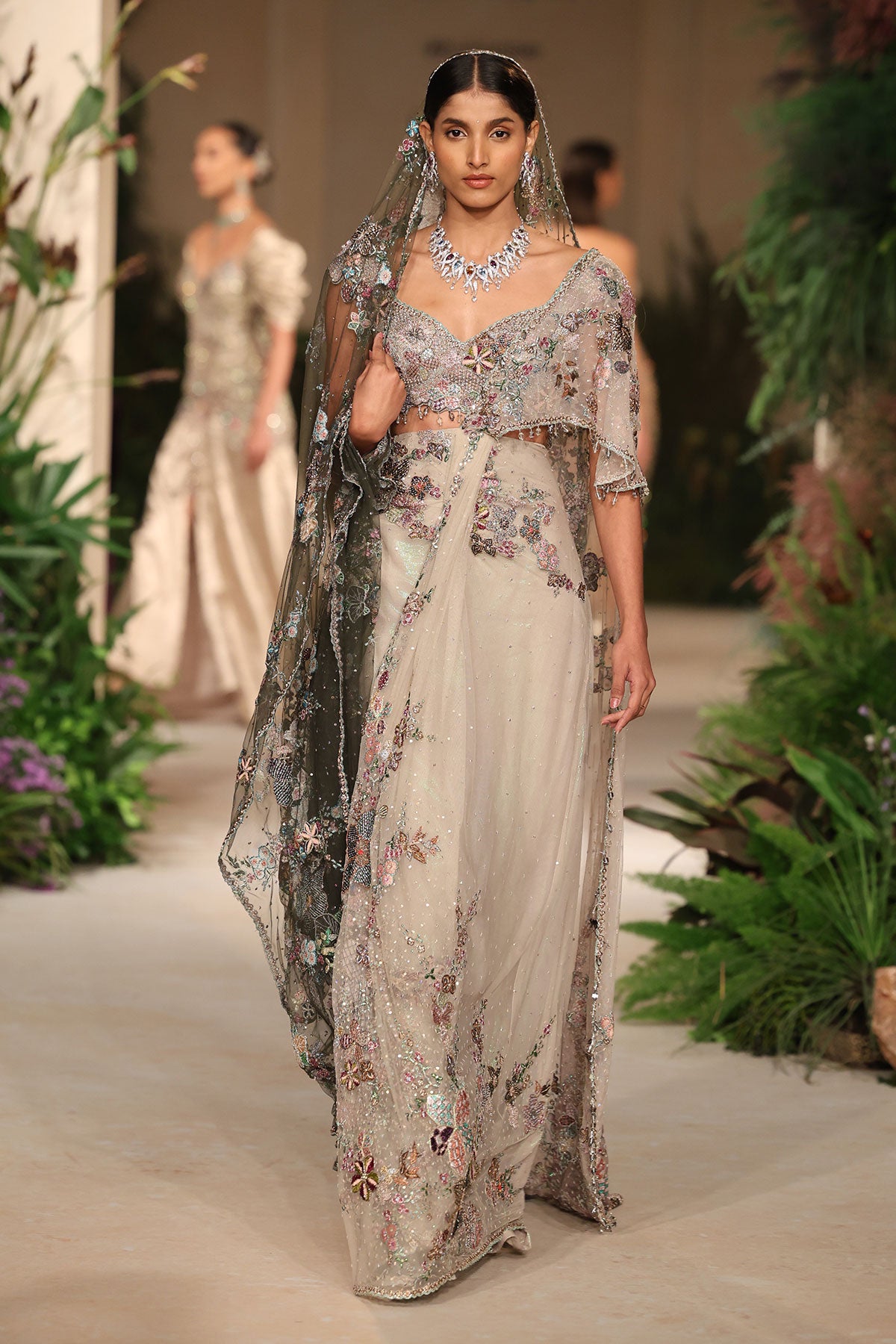 “Ivory tulle saree showcasing soft pleated drape and minimal, elegant styling.”