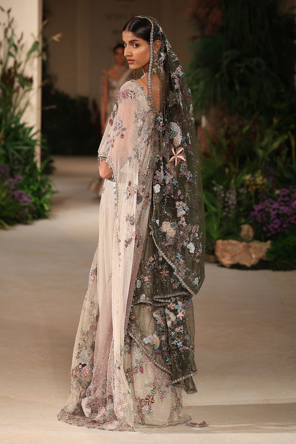 “Sheer ivory tulle drape saree with delicate pleating and modern styling.”