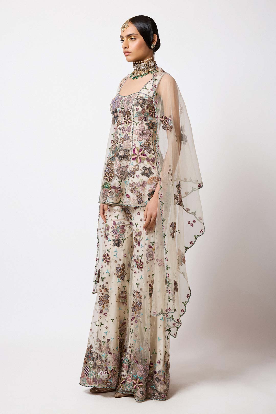 Woman wearing Aisha Rao light ivory net short kurta front view