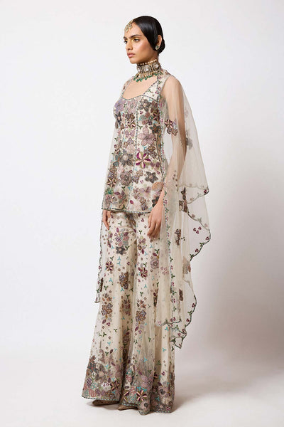 Woman wearing Aisha Rao light ivory net short kurta front view