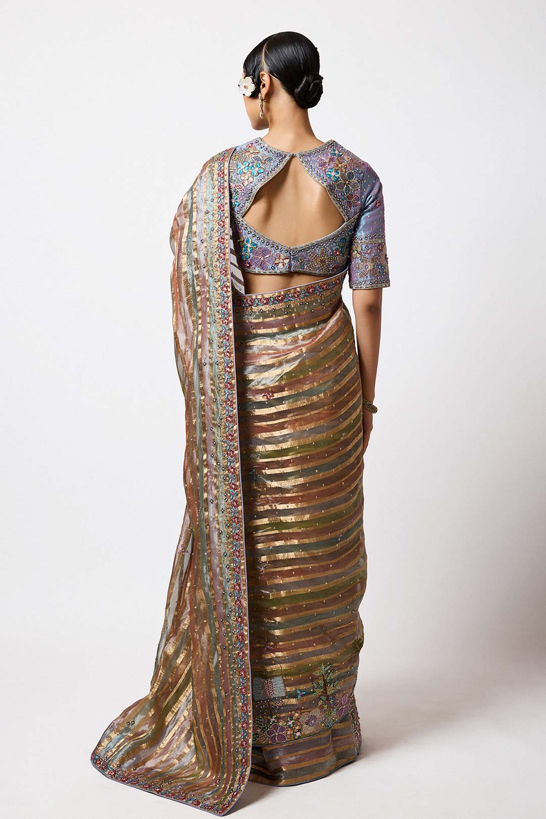 Woman in multicolour tissue brocade saree left profile