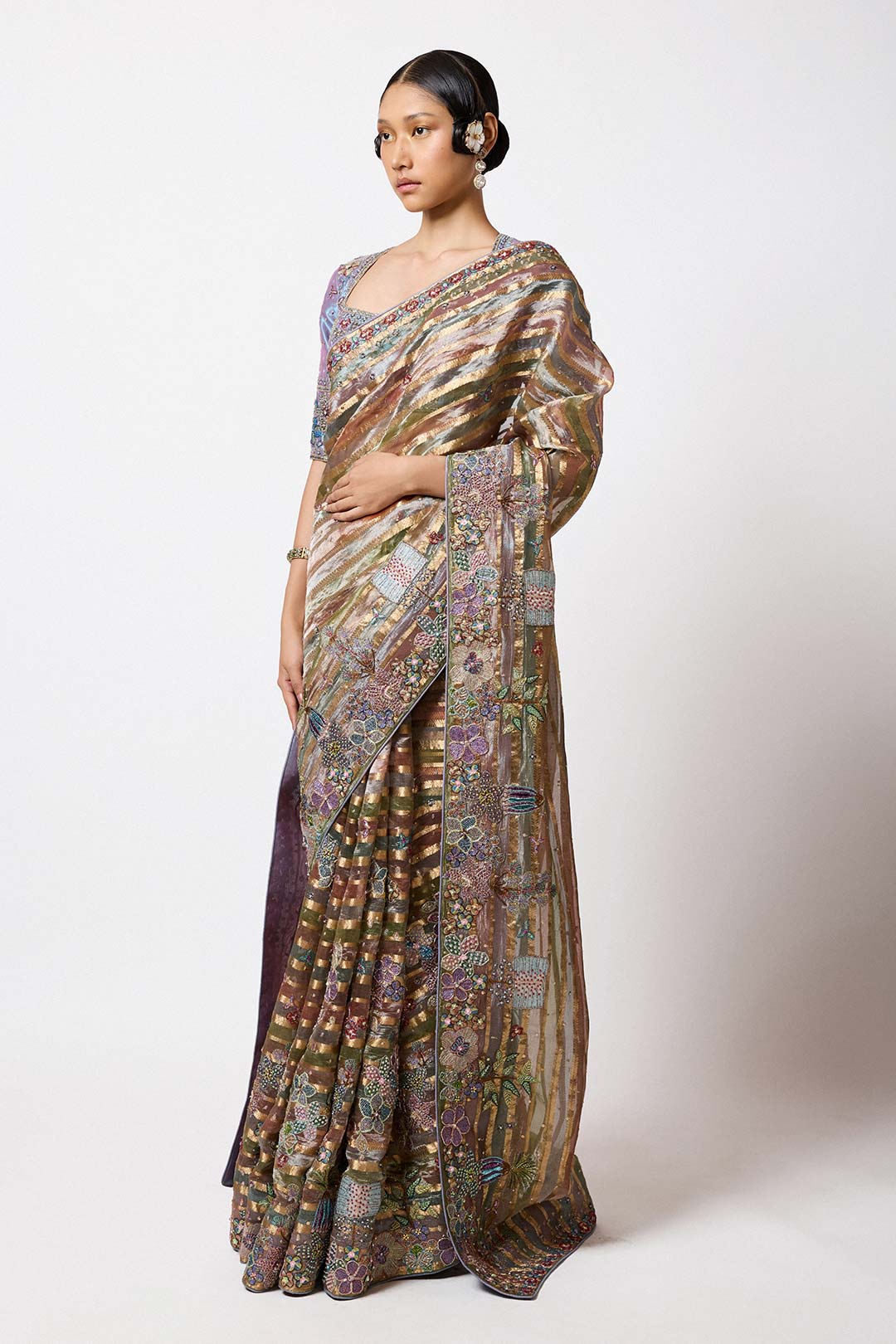 Woman in embellished Banarasi saree right profile