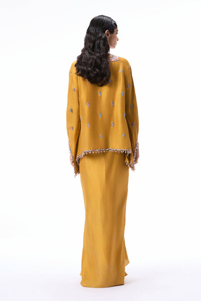 Back profile of the mustard applique embellished dupion silk kurta paired with the pleated draped skirt.