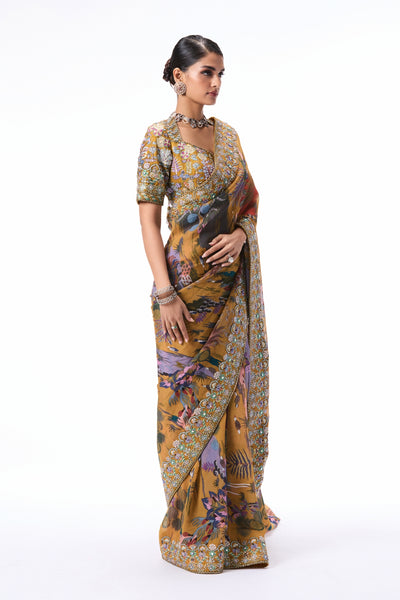 Side angle view of the mustard printed viscose organza saree featuring applique border detailing.