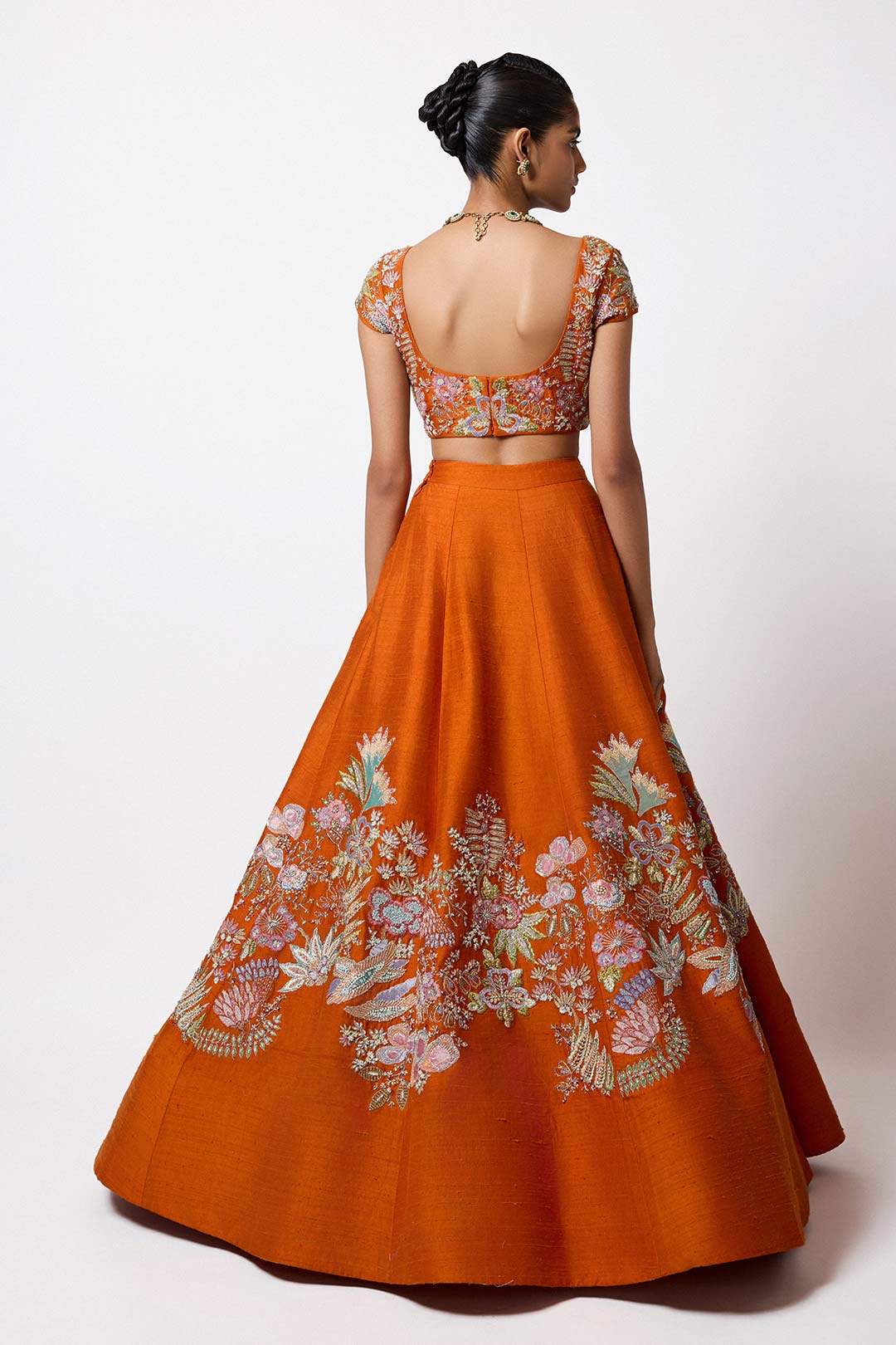 Woman in raw silk lehenga with blouse back profile view