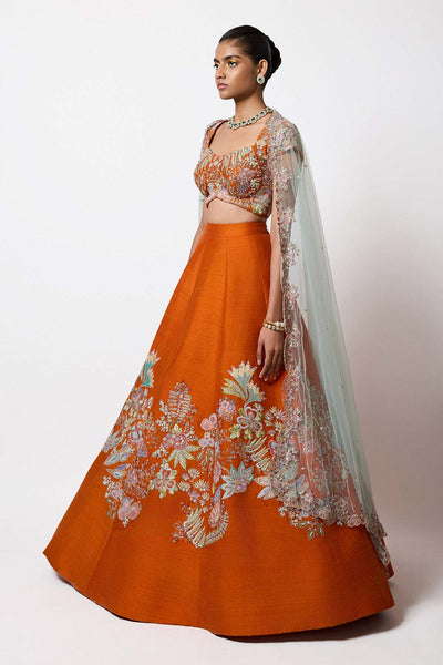 Left side view of orange raw silk lehenga by Aisha Rao