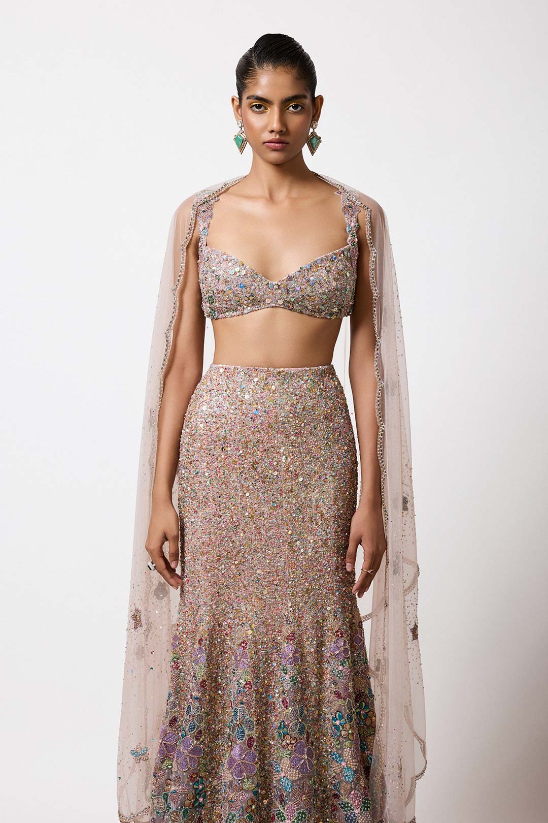 Woman in pink applique embellished lehenga right profile