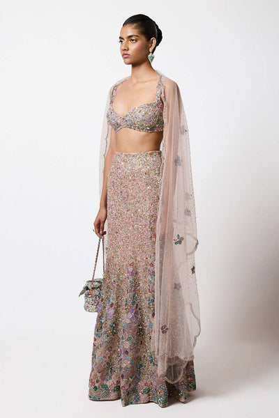 Woman in pink fish cut net lehenga side profile