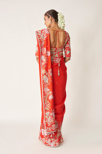 Back look of red embellished blouse and saree
