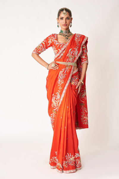 Woman wearing red embellished dupion silk saree